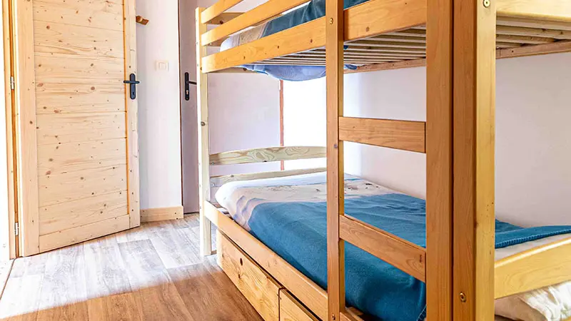 Bright bedroom with bunk beds, parquet flooring