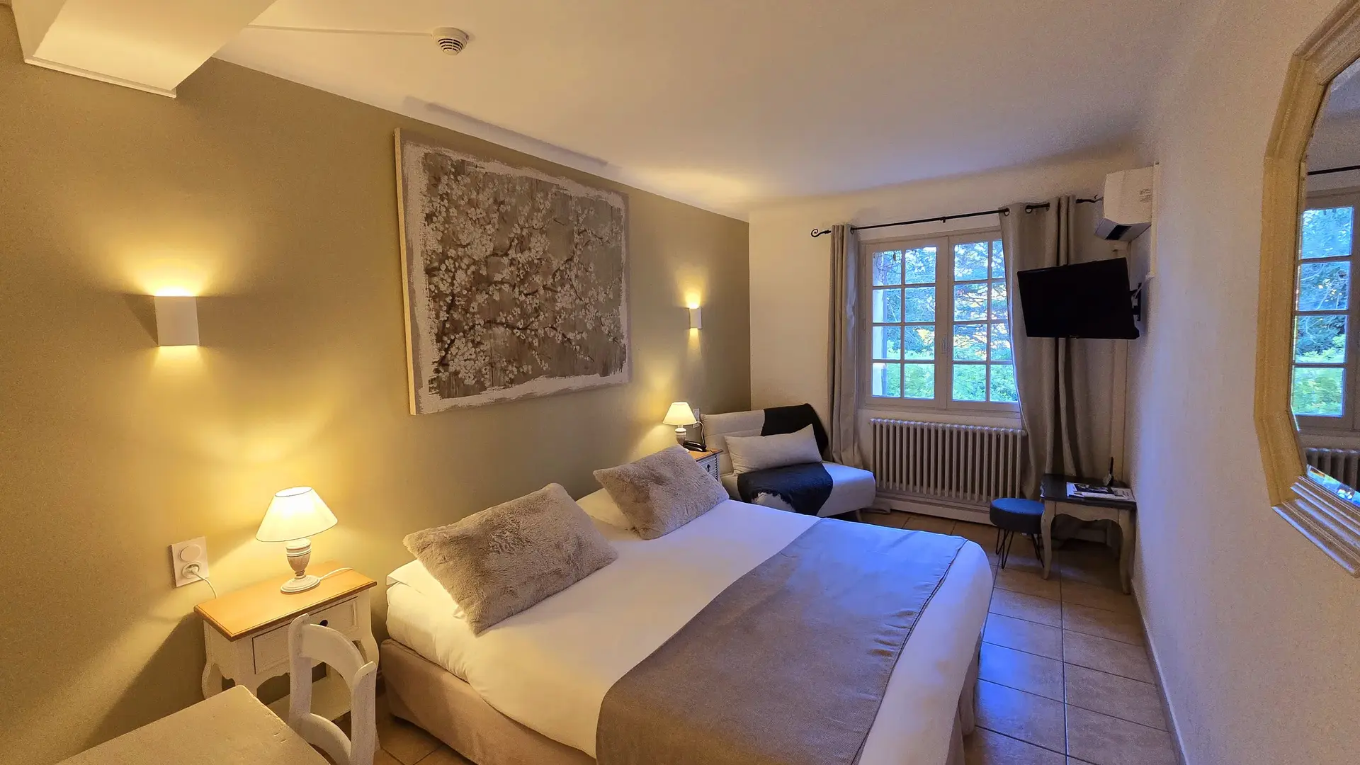 Une chambre lumineuse et chaleureuse aux tons doux, idéale pour un séjour reposant.