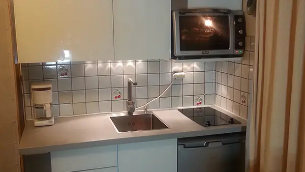 Tiled kitchen, electric hobs and sink
