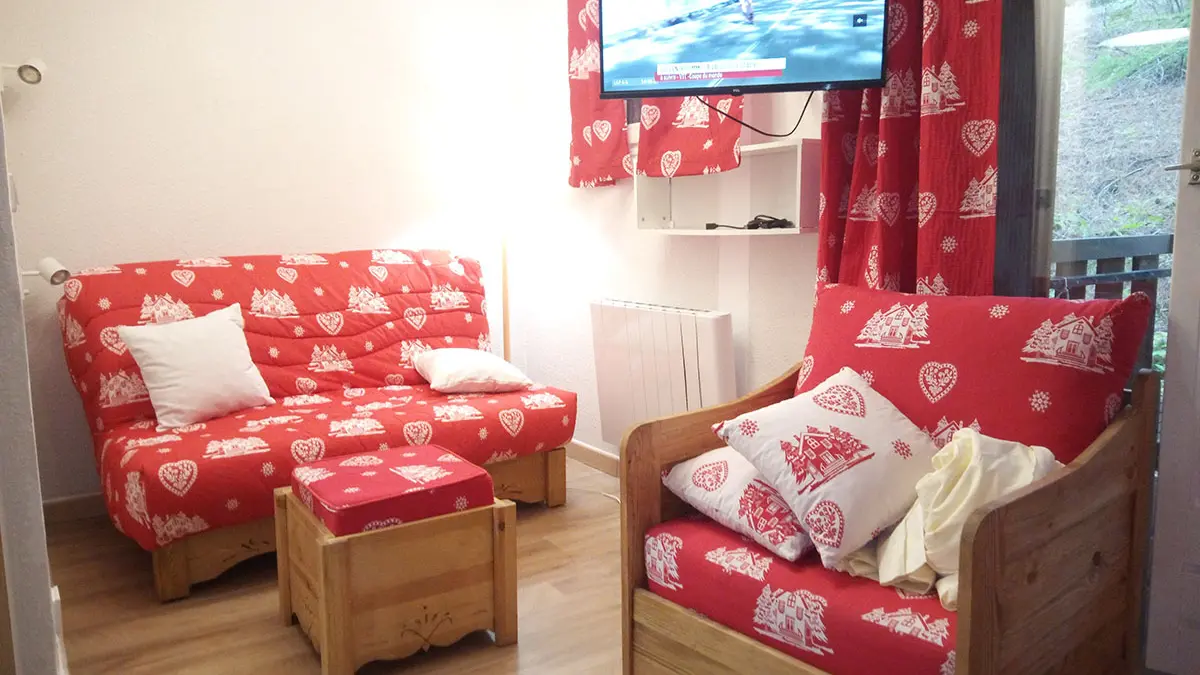 Bright and comfortable studio apartment with sofa and armchairs, TV, wooden furniture, window
