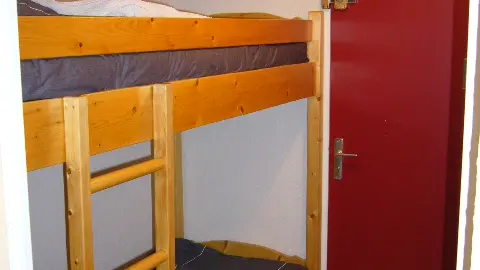 Children's bedroom corner with bunk beds and entrance door
