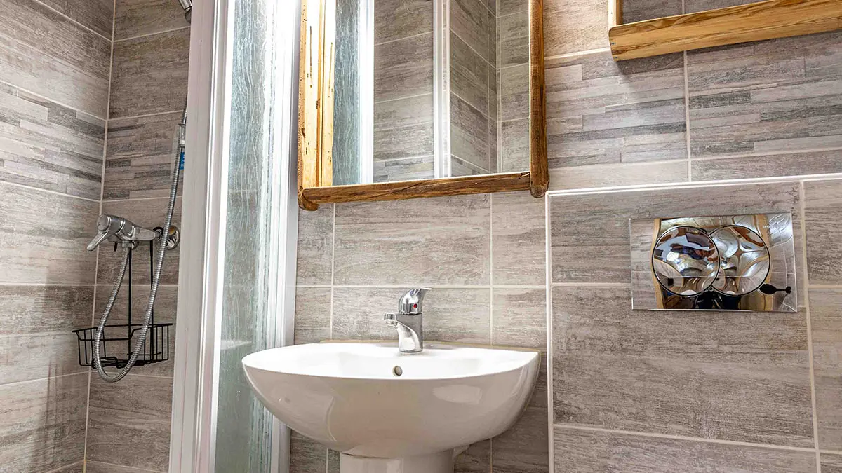 Bright modern bathroom with shower tray, sink, wooden furnishings