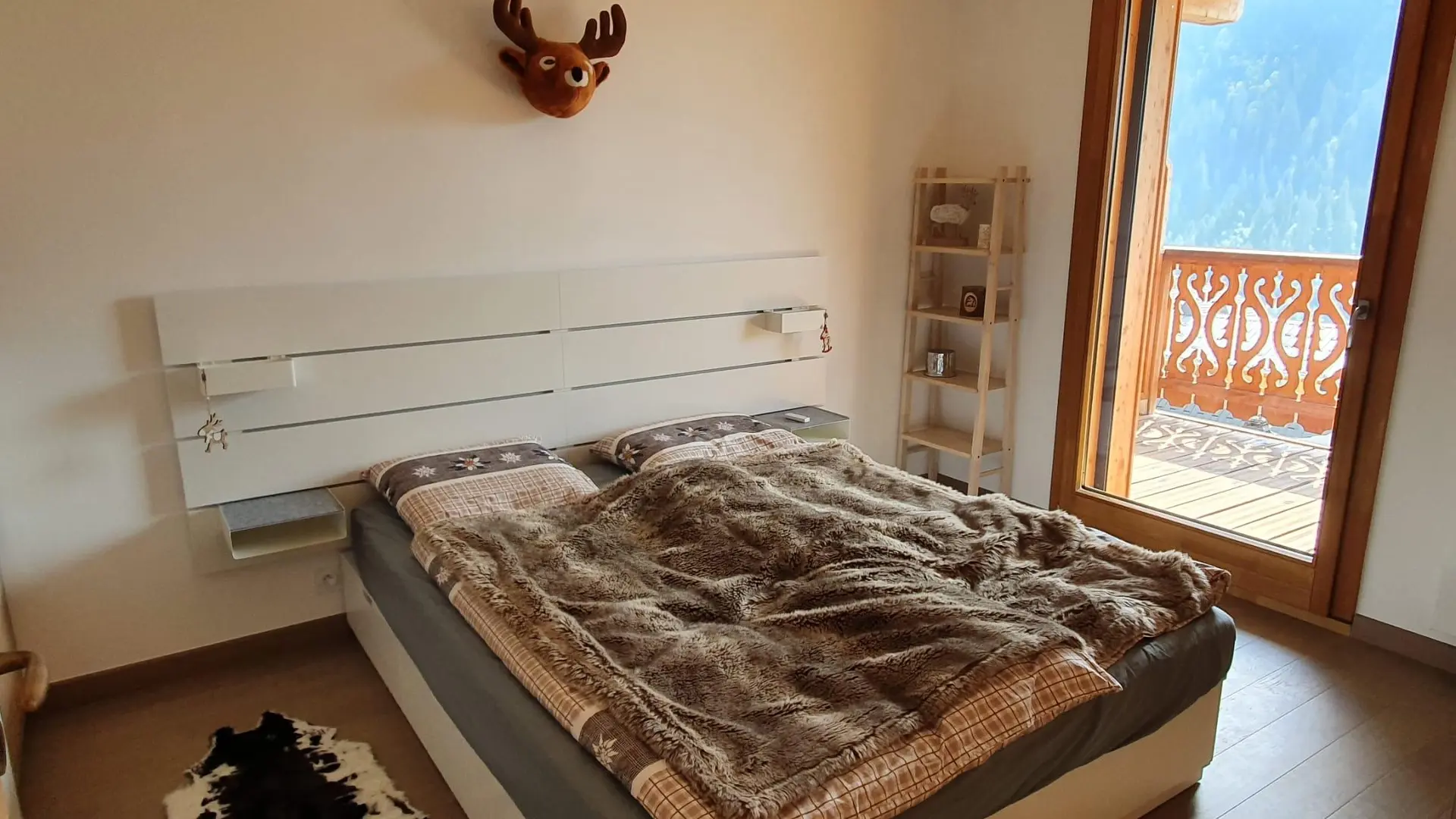 Chambre avec lit double, porte fenêtre donnant accès au balcon