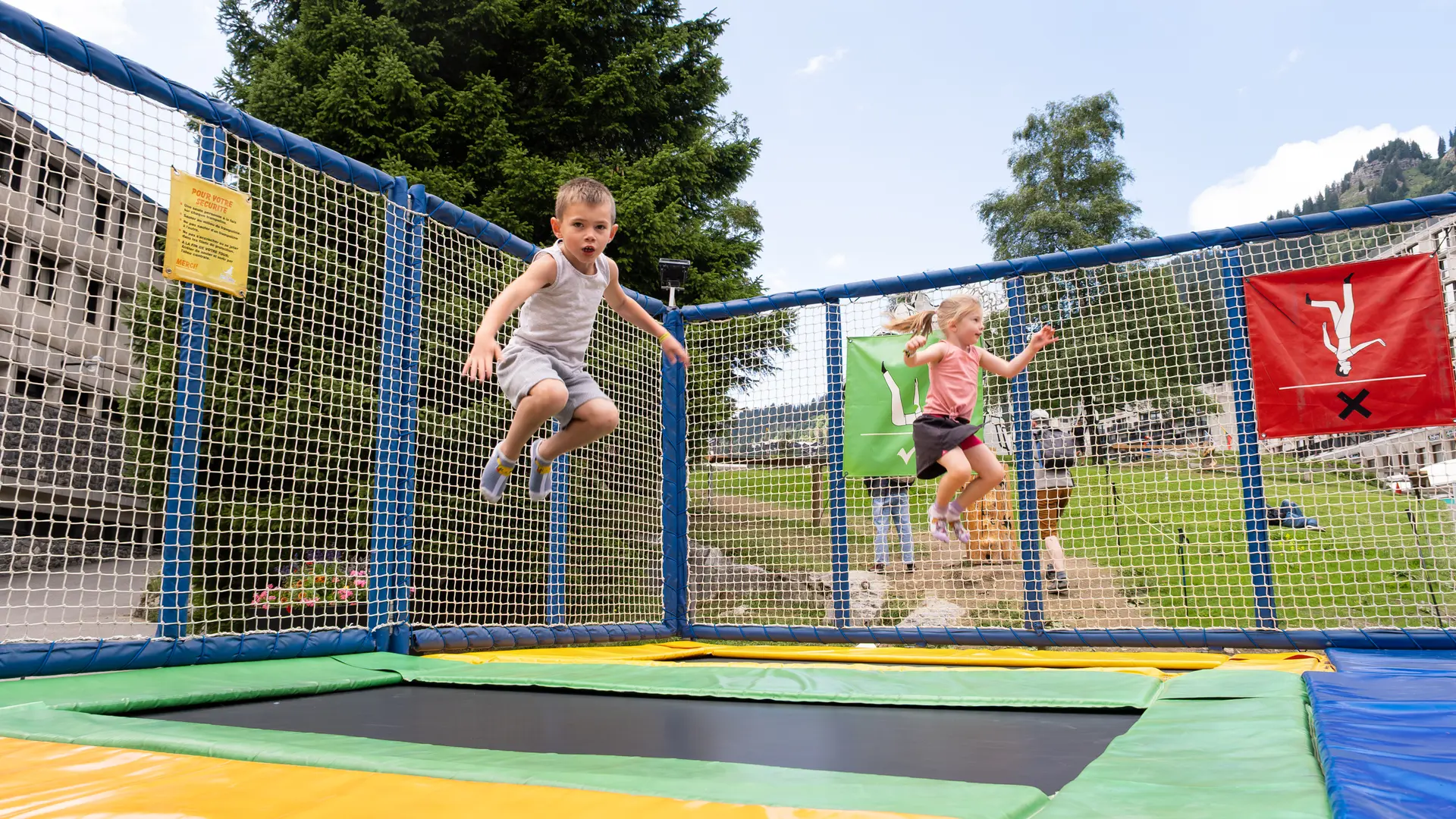 2 children jumping on the trampoline