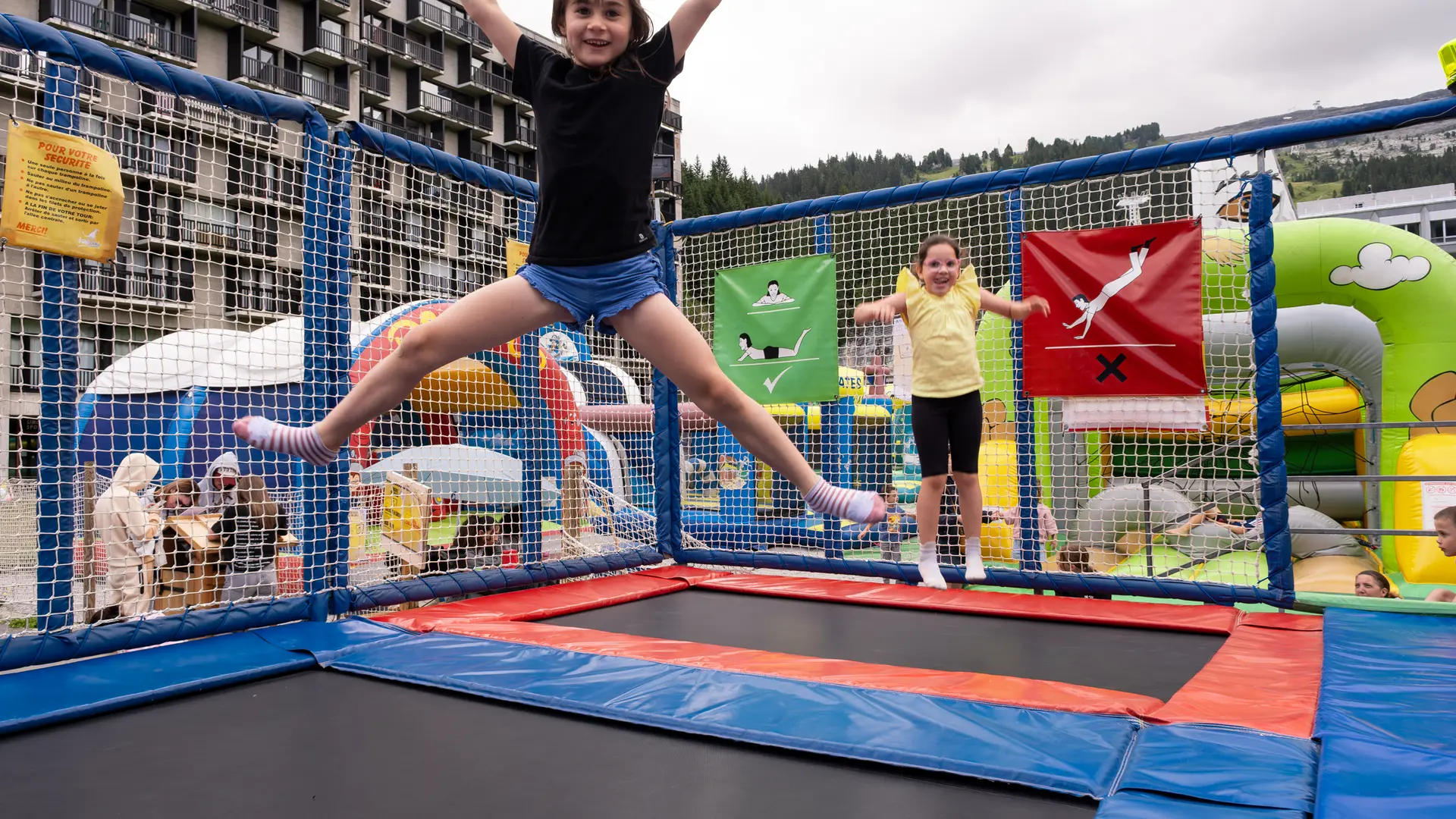 2 girls having fun on trampolines