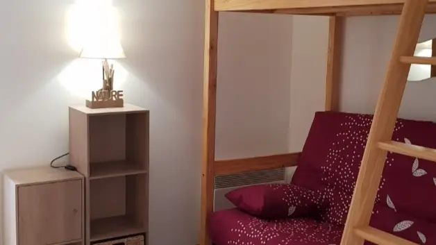 Living area with sofa and mezzanine bed, wooden furniture