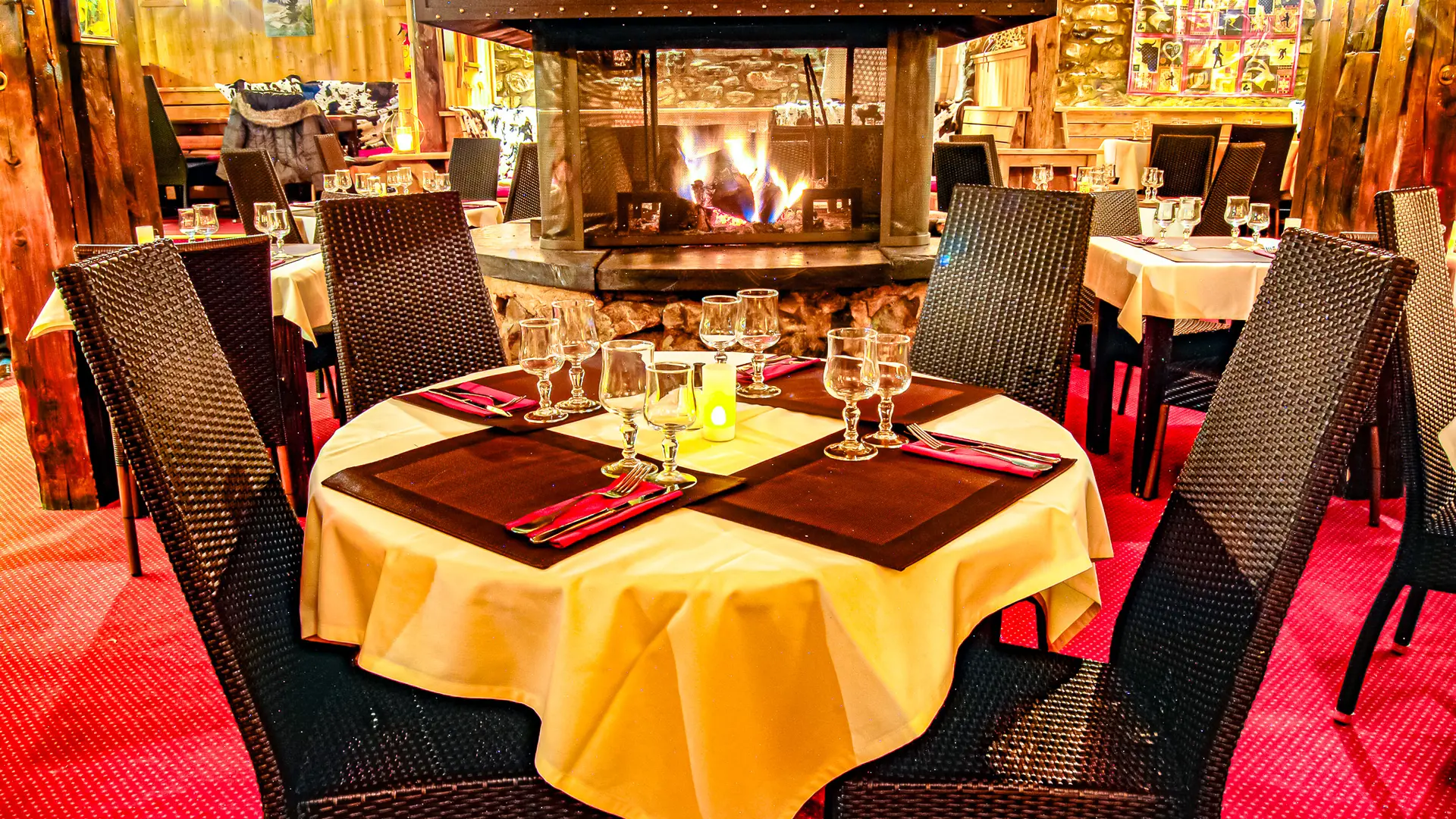 Inside the restaurant overlooking the central fireplace with a table for 4 in the foreground