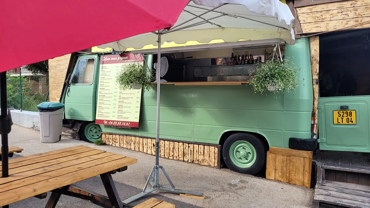 View of the pizza truck, green, terrace nearby