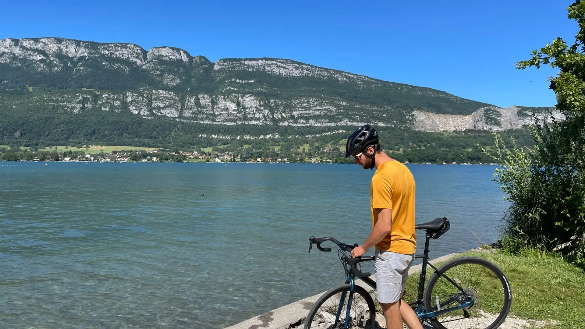 cyclist by lake Annecy