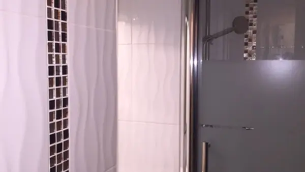 Tiled bathroom with shower tray