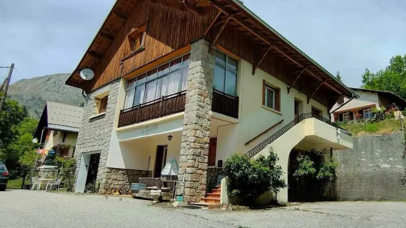Chalet with stone facade and glass balcony