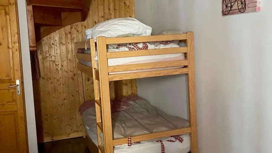 Bedroom with bunk beds, wooden furniture