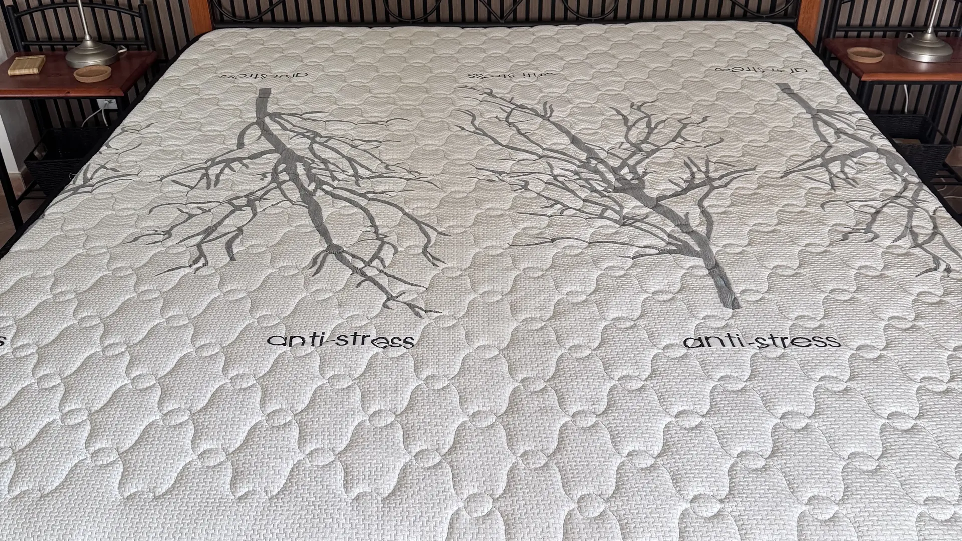 Un lit 180x200 entouré de table de chevet.