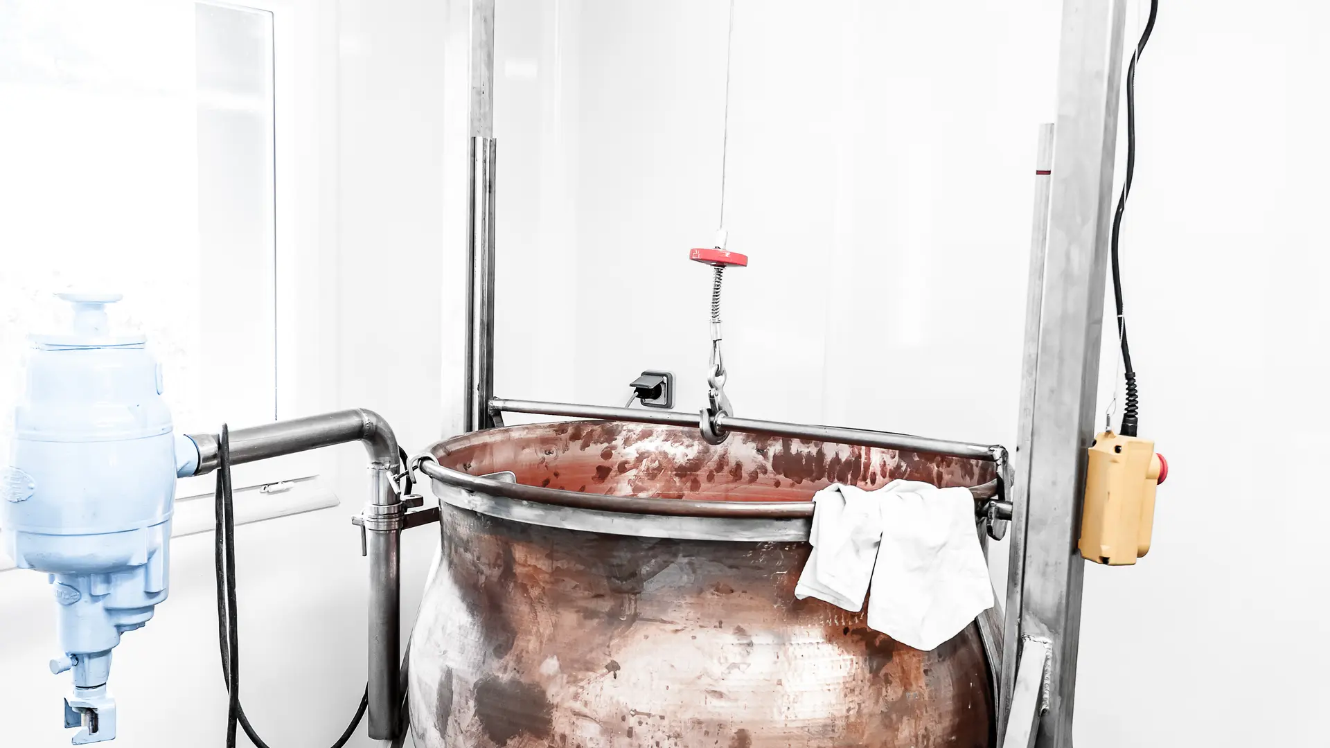 Milk is heated in a copper cauldron