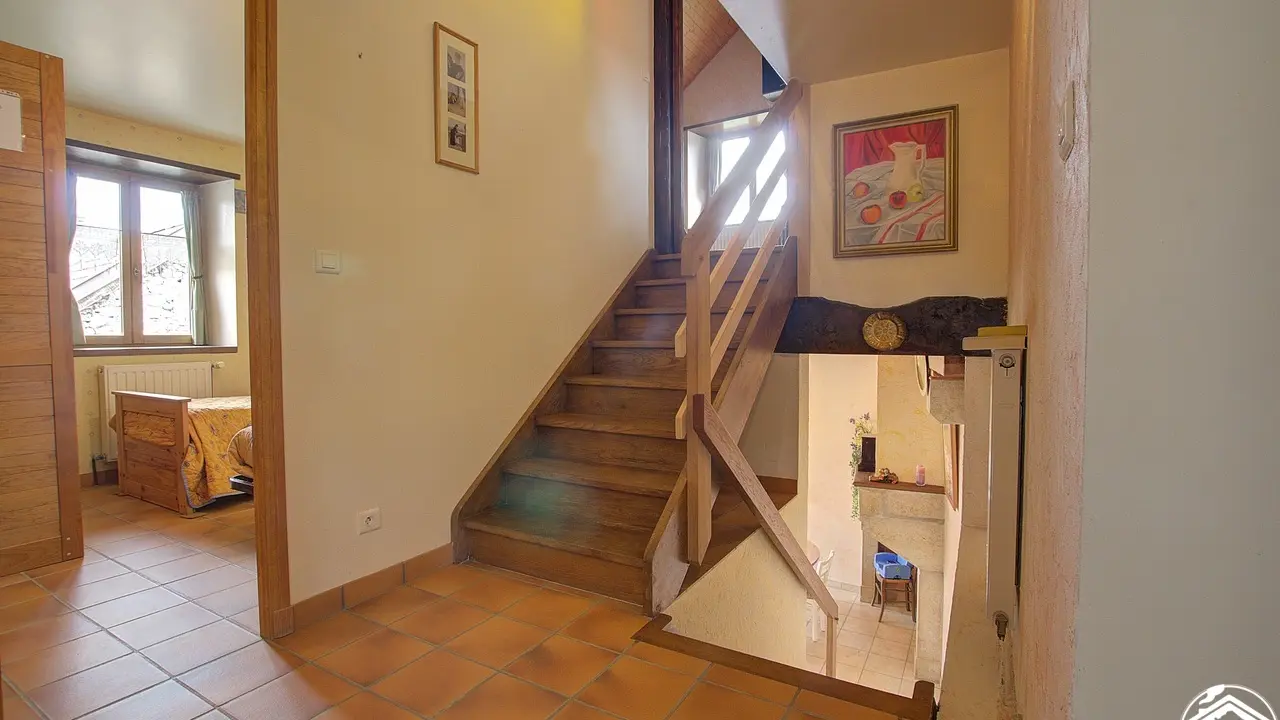 Palier qui dessert les 2 chambres, la salle de bains et les toilettes séparés. Escalier pour accéder au salon et grande chambre mansardée.