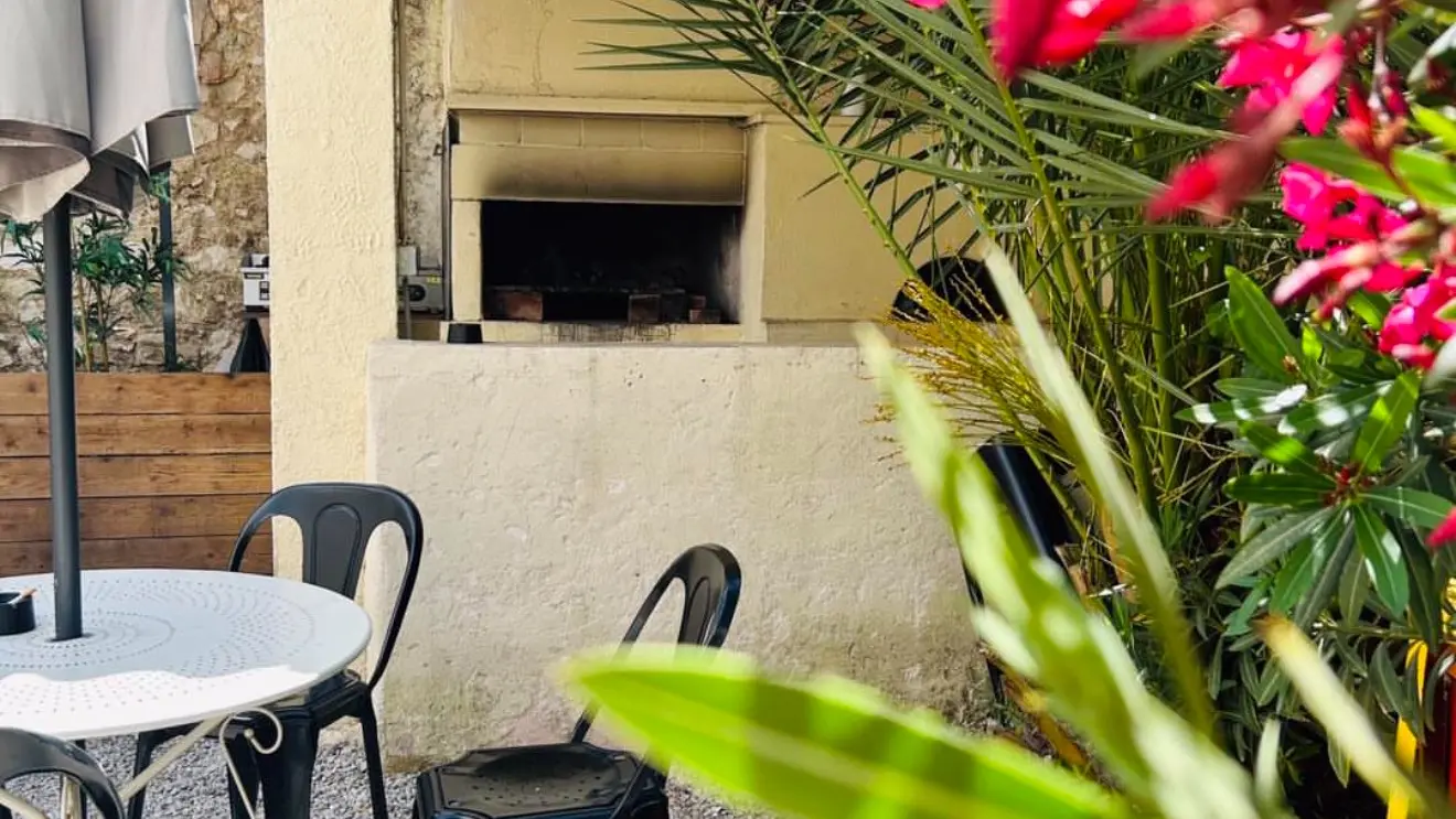 exterieur avec vue sur le barbecue et laurier rose en fleur