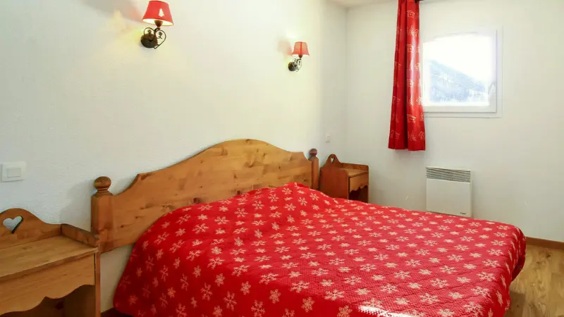 Bedroom with double bed, wooden furniture, window