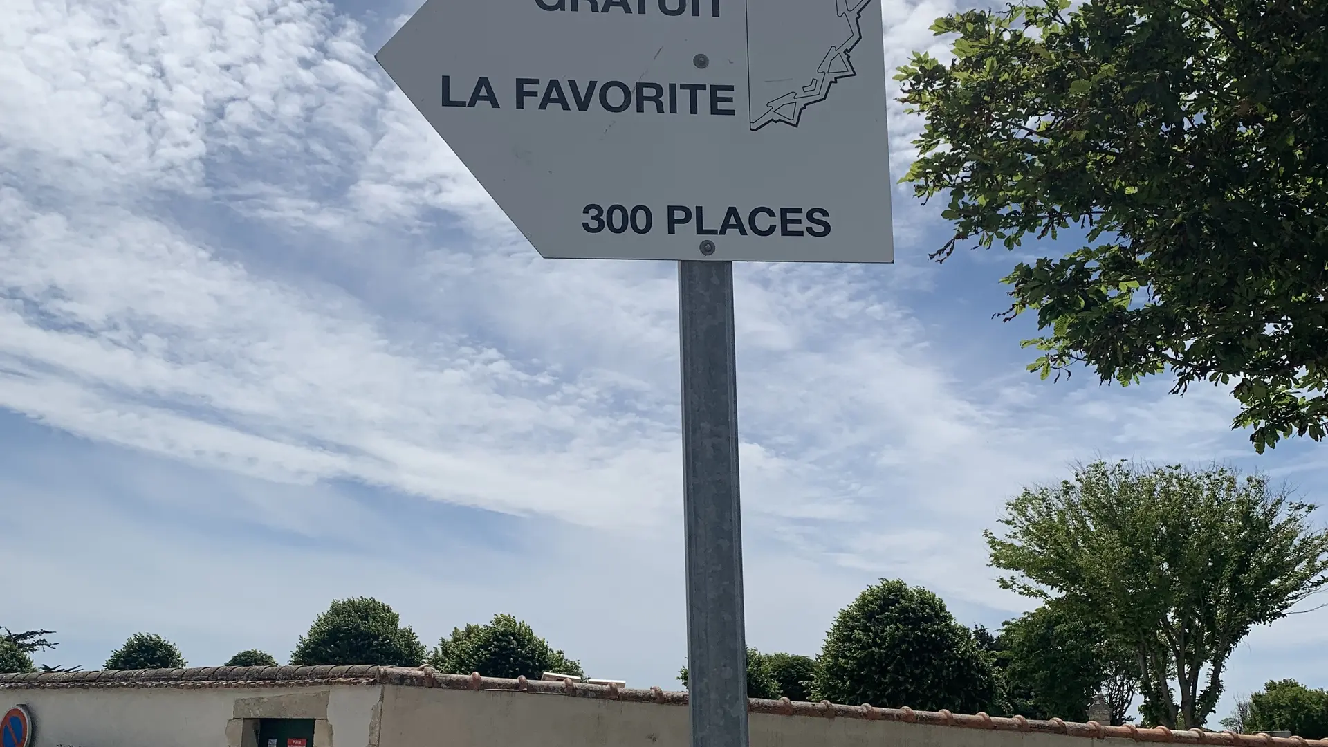 Señal de dirección al estacionamiento.