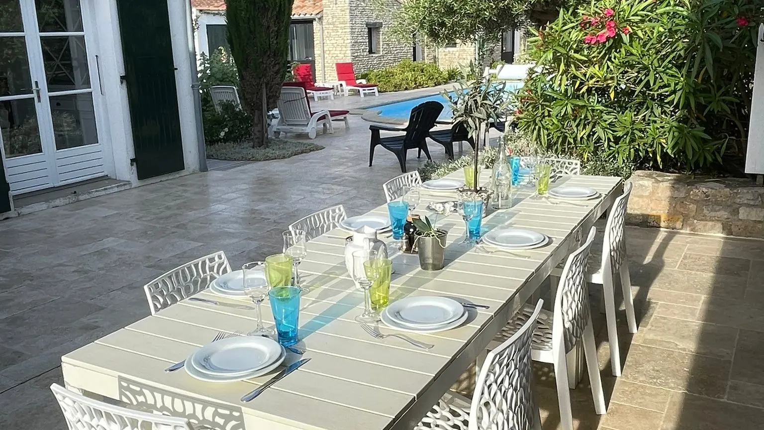 Large outdoor table with views of the pool and garden