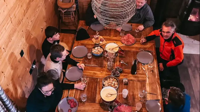 Dining room with guests at the Alpine Chalet Mont Plaisir, a peaceful mountain refuge in Samoëns, Haute Savoie
