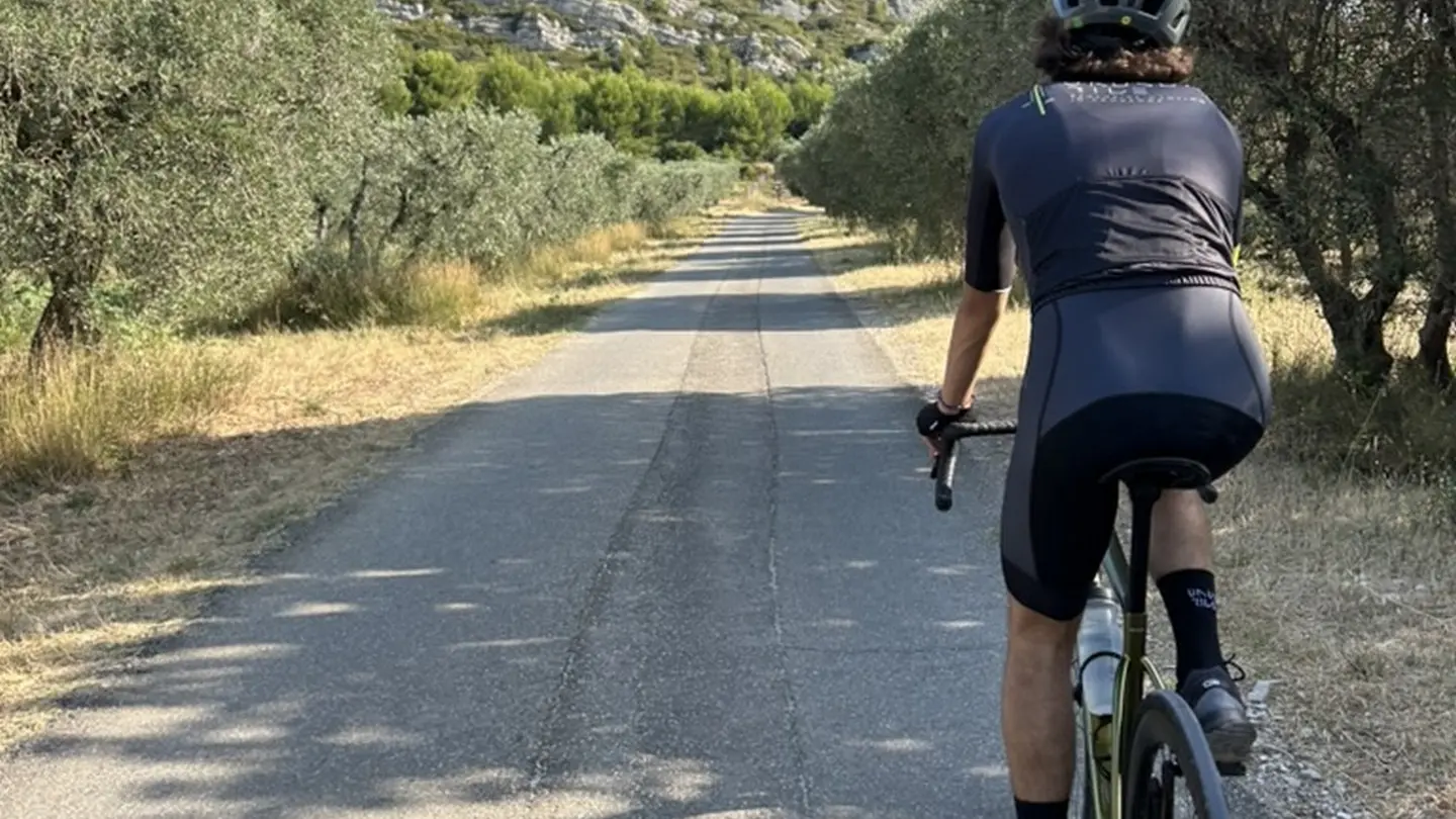Unusual Ride Cycling tour guide in Aureille Cyclist and olive trees