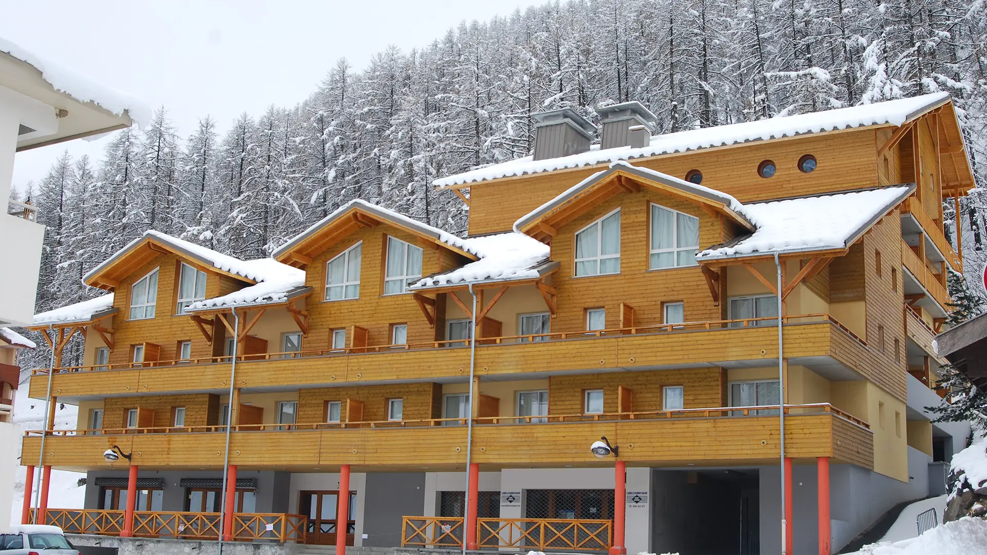 View of the 4-story residence with snow-covered terraces