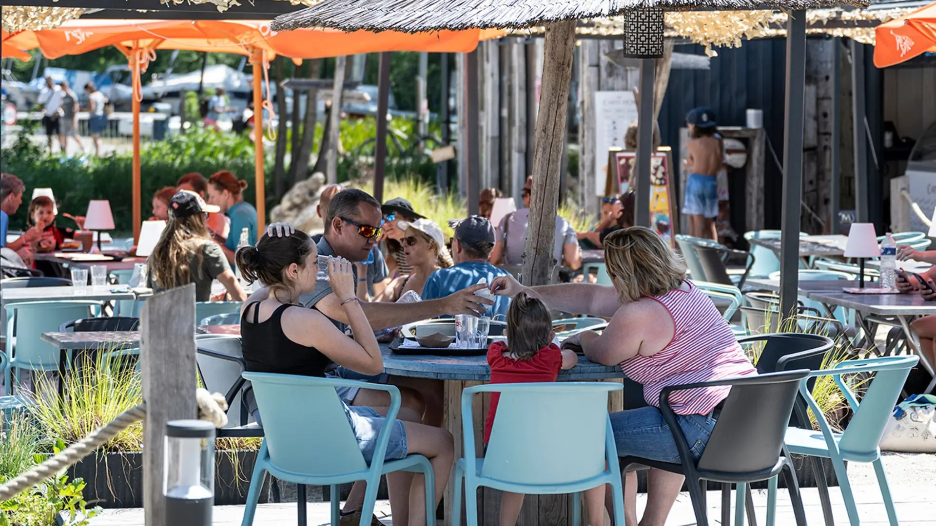 table family and straw parasol