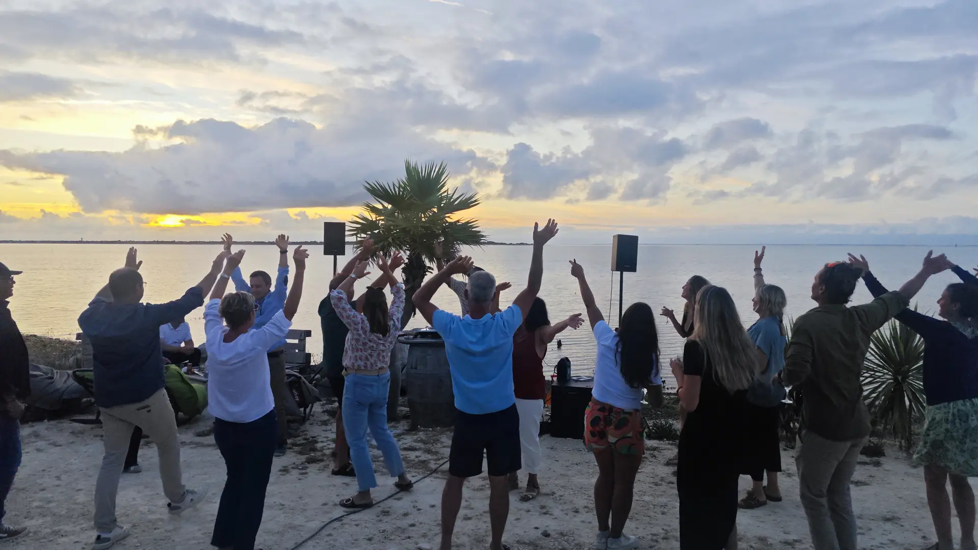 Group of people dancing with a sea view during a private use of the cabin