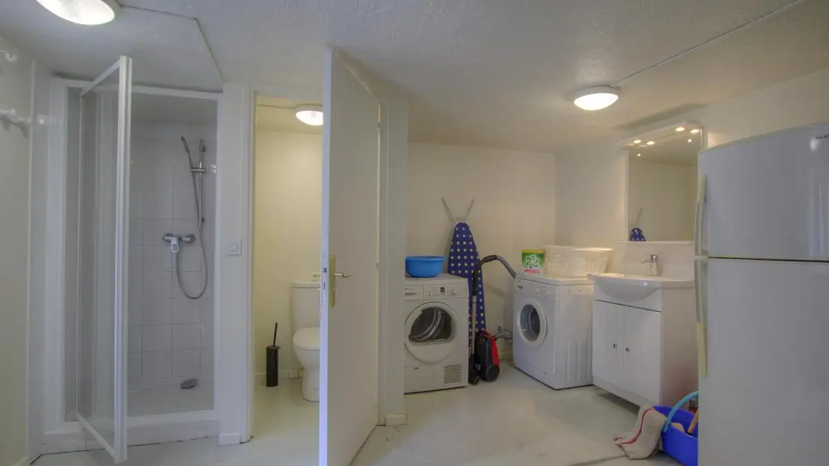 Buanderie avec l-linge, s-linge, frigo d'appoint, douche et wc