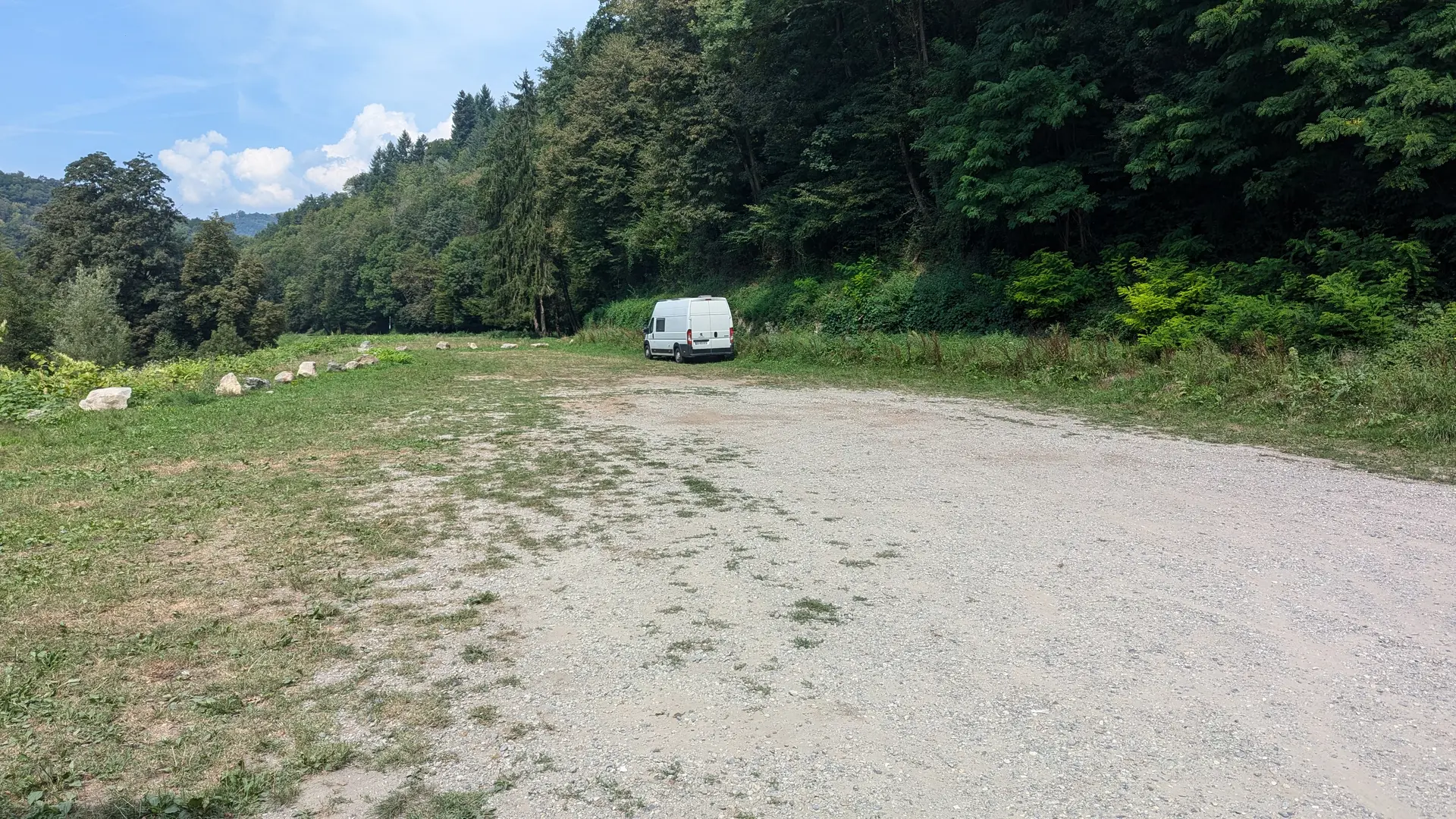 Camping-car blanc sur une aire naturelle herbeuse