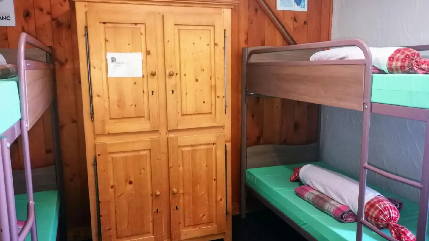 Dortoir de 4 lits au premier étage avec lavabo et armoire