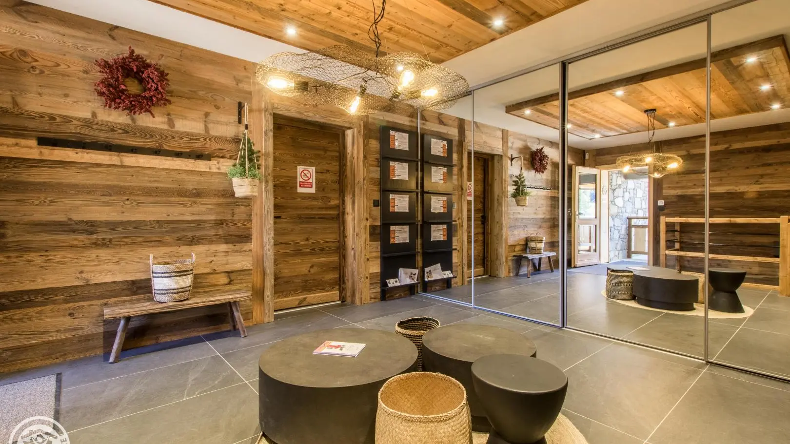 Entrée du châlet, niveau 0, accessible par l'ascenseur, vaste espace de rangement avec miroirs et accès au niveau -1