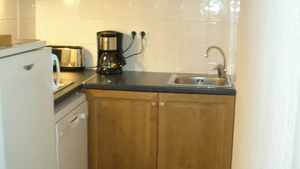 Kitchen area with wood furniture, parquet flooring