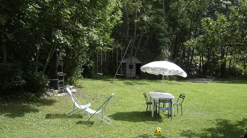View of the outdoor garden, children's play area, barbecue, garden table, vegetation