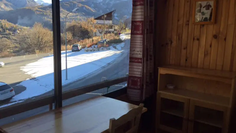 Bright room with outdoor access, wooden furniture, large window