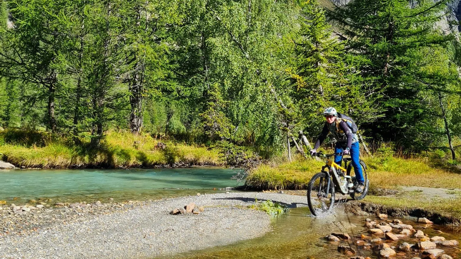 un VTTiste traversant une rivière