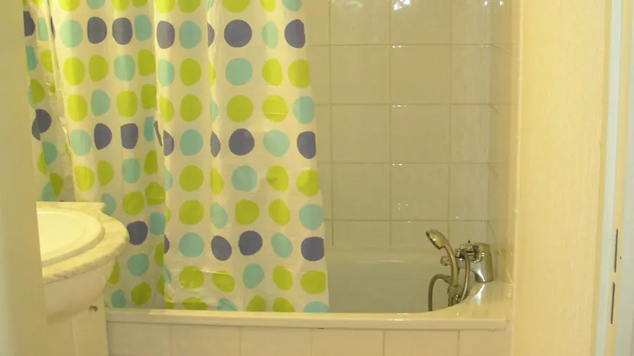 Tiled bathroom with sink and bathtub