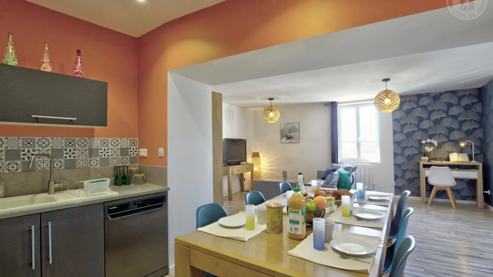 Pièce à vivre avec cuisine ouverte sur l'espace repas et le salon détente.