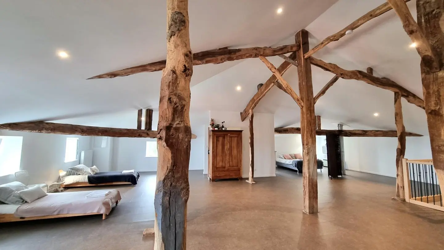 Chambre familiale 4 pers. sous combles, avec belle charpente apparente. Située au-dessus des 3 autres chambres, isolation phonique limitée.