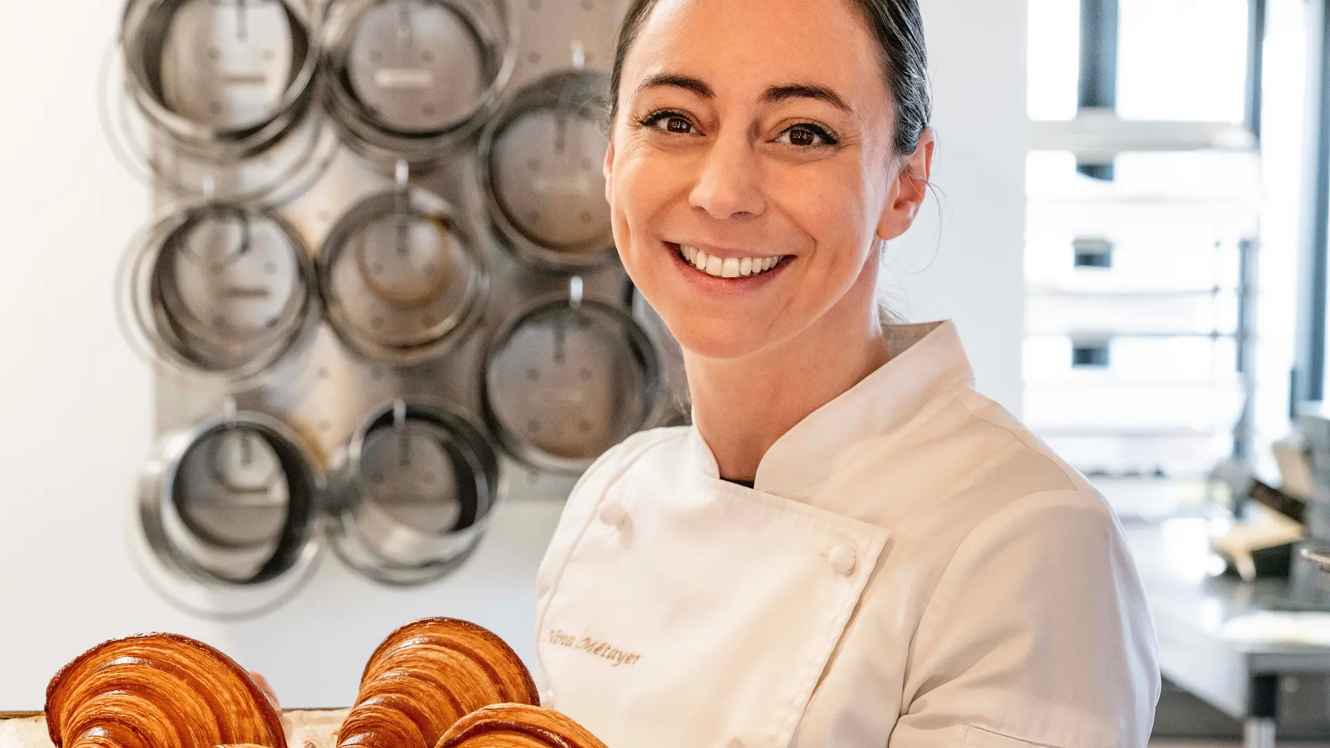 Croissants displayed on a tray in a bakery