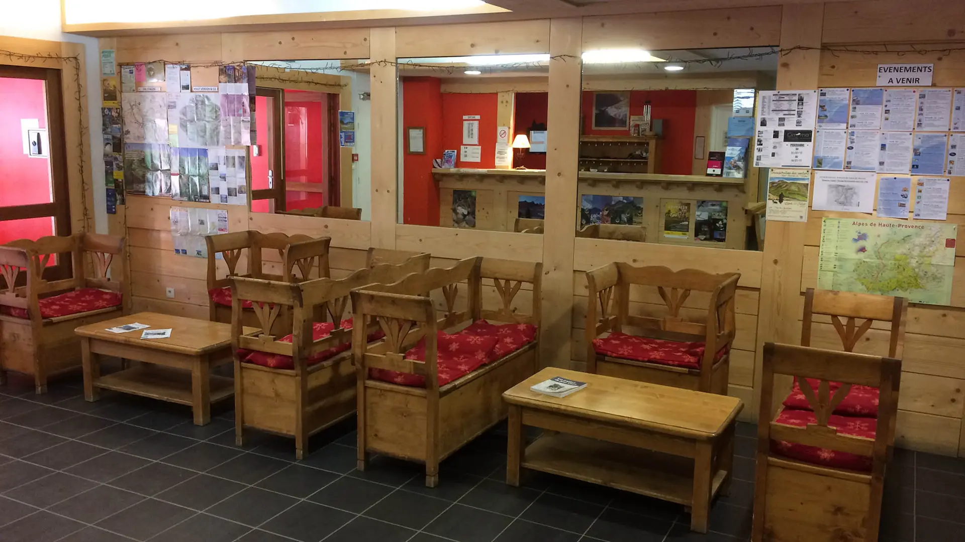 Entrance hall of the residence, wooden tables and chairs, notice boards, reception.