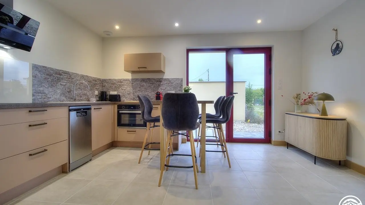 Cuisine aménagée et fonctionnelle.
Elle ouvre sur une petite terrasse