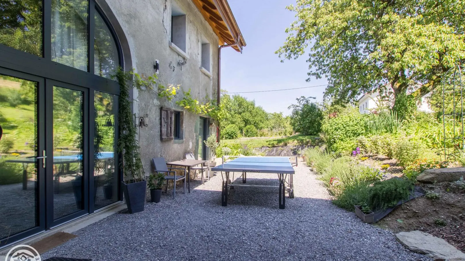 Terrasse orientée Sud (coté porte d'entrée du gîte) avec table de ping-pong