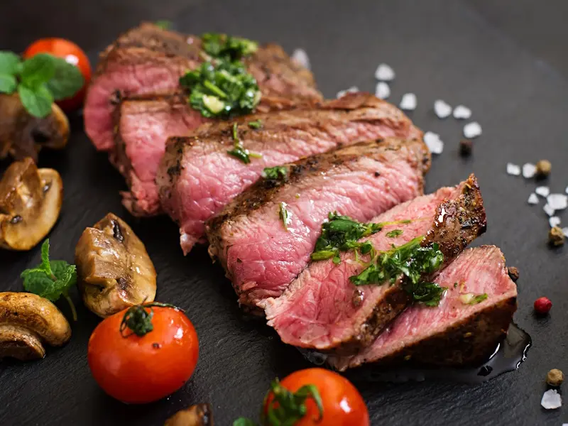 Juicy steak medium rare beef with spices and grilled vegetables.