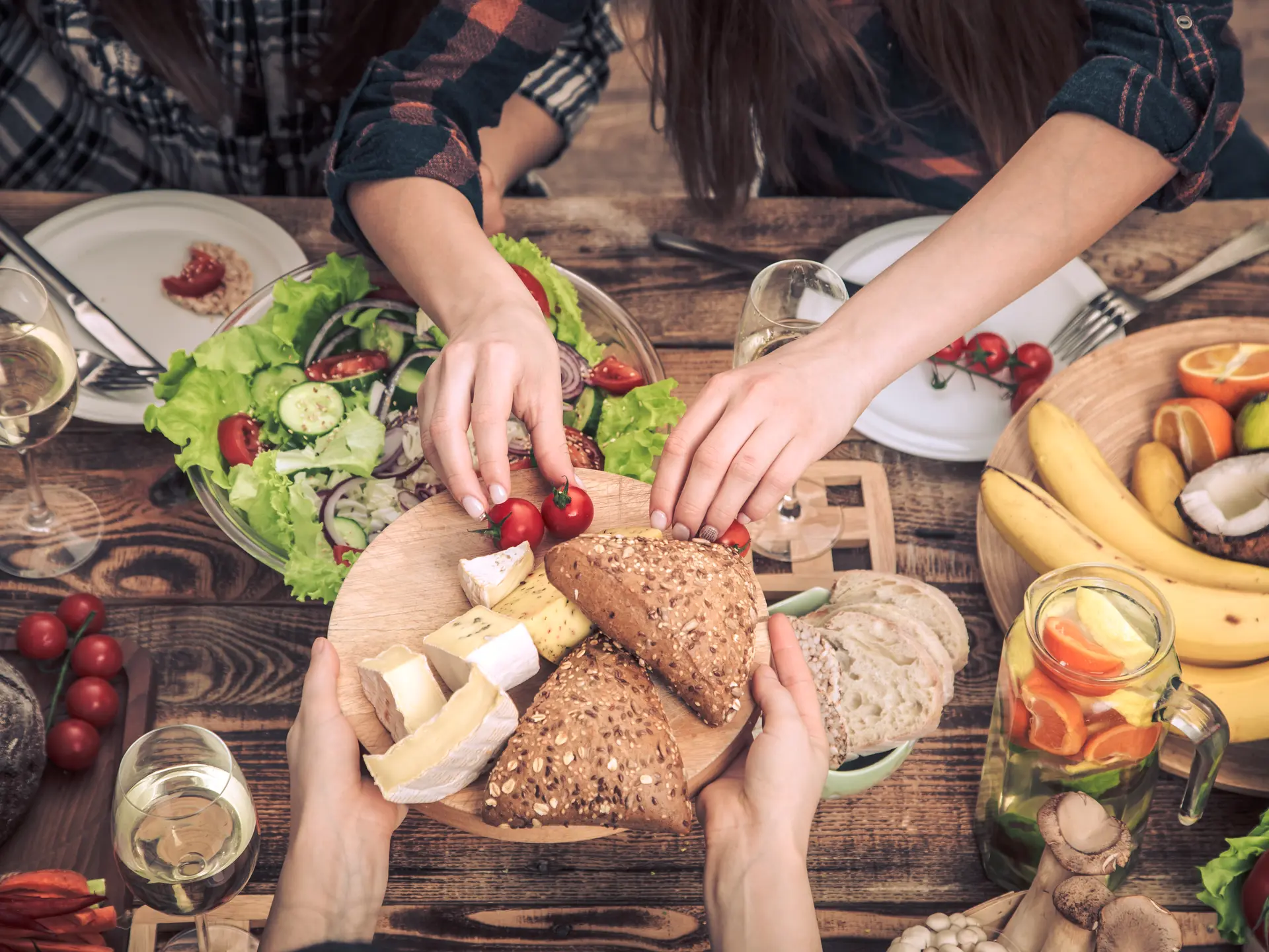 Enjoying dinner with friends. Top view of group of people having dinner together