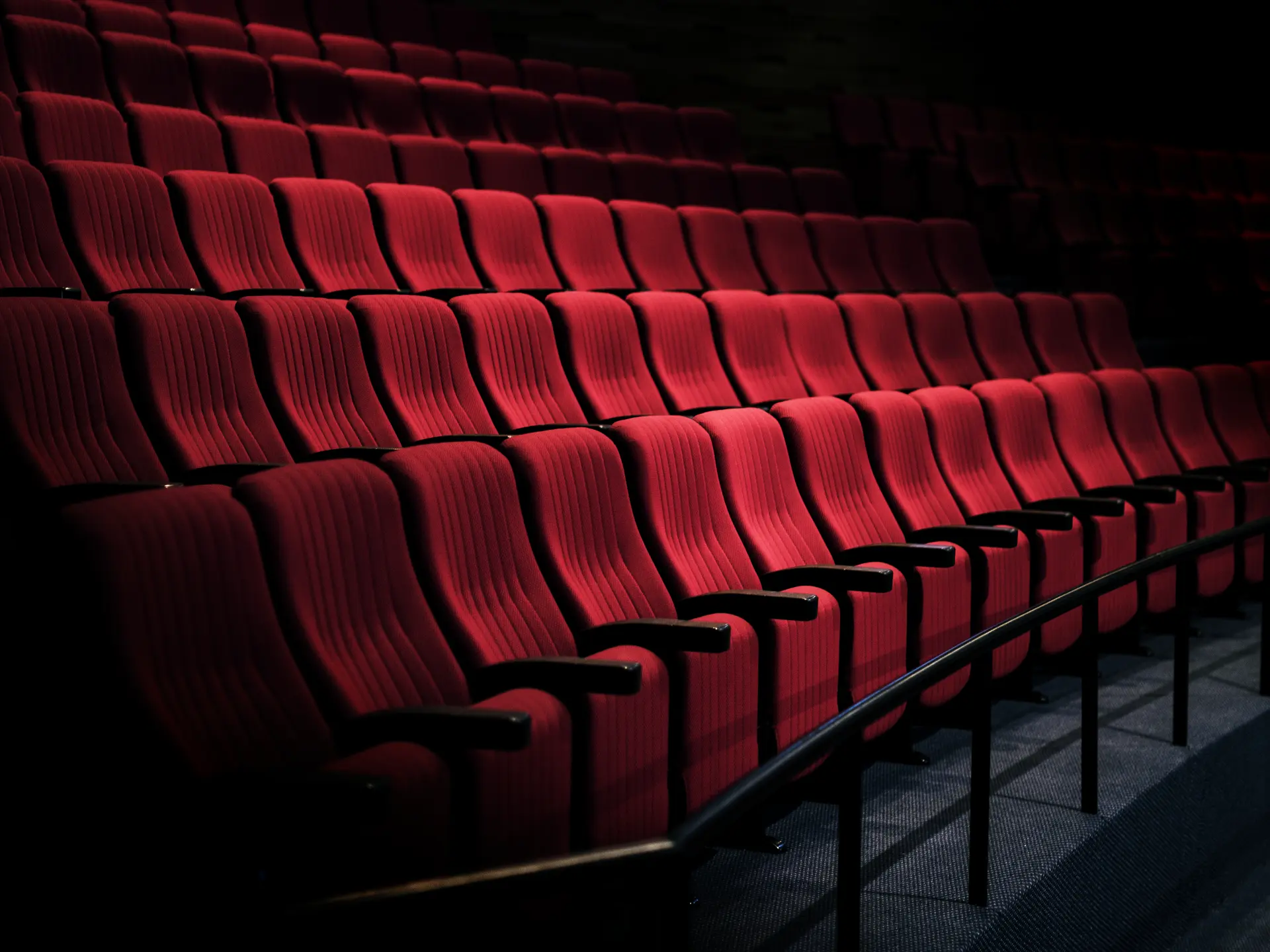 Rows of red seats in a theater