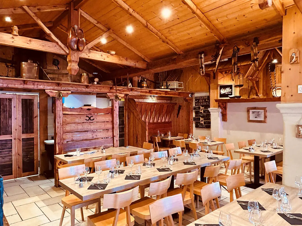 Restaurant dining room, wooden tables and chairs, interior decoration and wooden roof, warm atmosphere