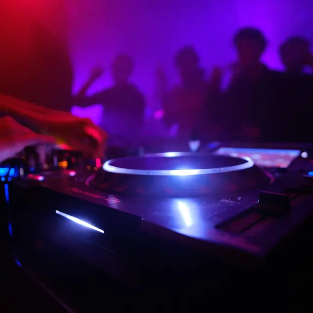 closeup-shot-dj-s-equipment-people-dancing-club