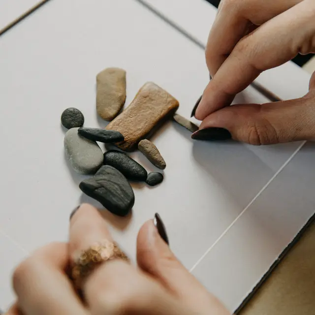 Stone figures embedded to the blank paper