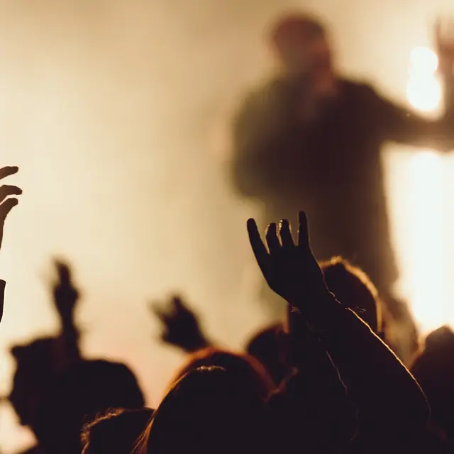 dancing-concert-while-singer-is-performing-surrounded-with-lights